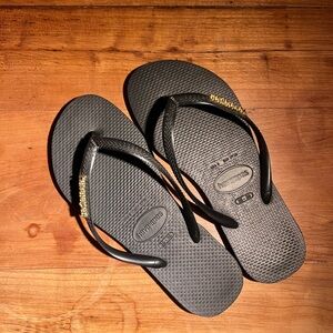 Havaianas Black Flip Flops with Gold Accents